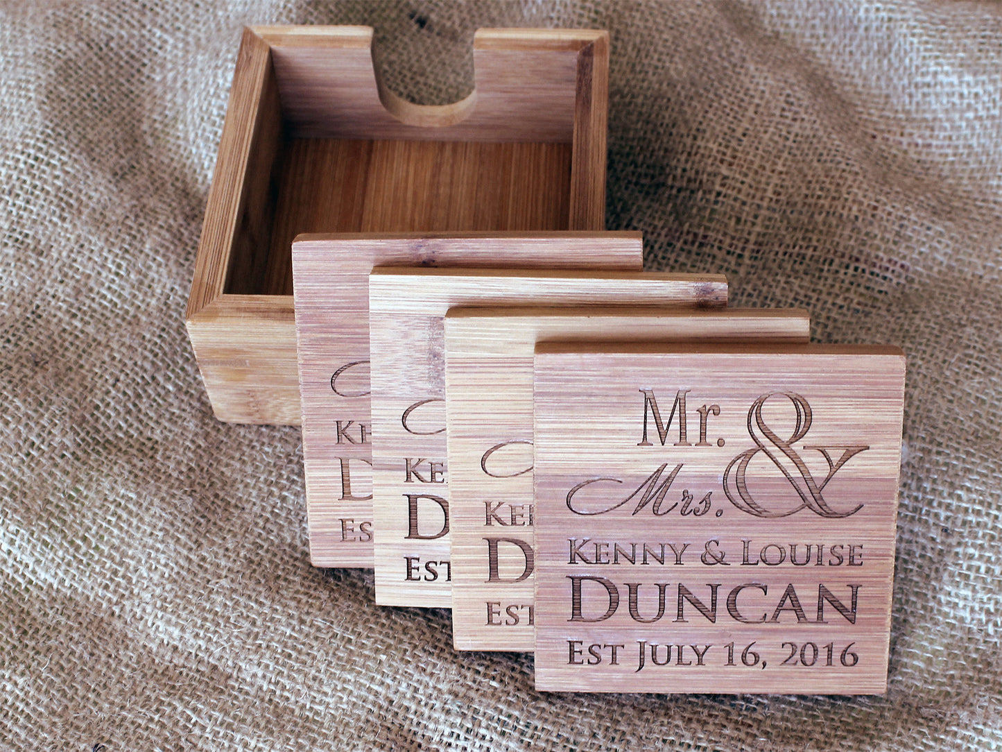Personalized bamboo coasters used as home décor on a coffee table
