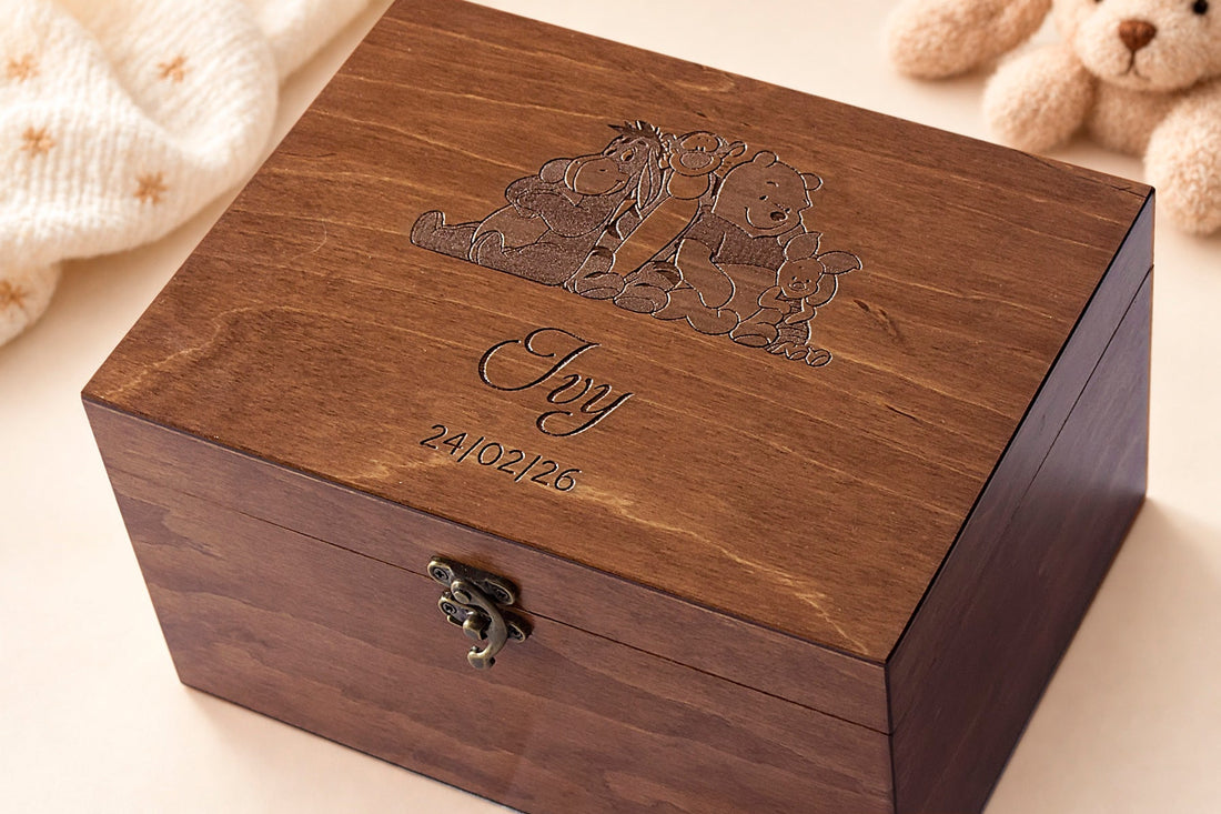 Personalized walnut-finish baby keepsake box engraved with Winnie the Pooh characters, the name Ivy and a birth date