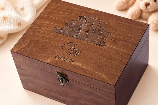 Personalized walnut-finish baby keepsake box engraved with Winnie the Pooh characters, the name Ivy and a birth date