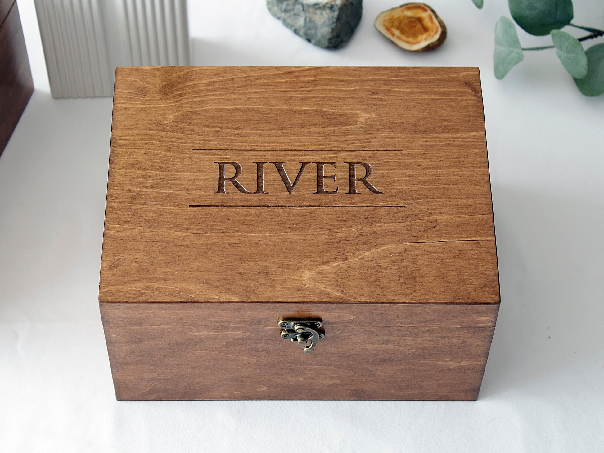 Custom handmade wooden keepsake box and pet urn with personalized name engraving, shown in a lifestyle setting on a white background
