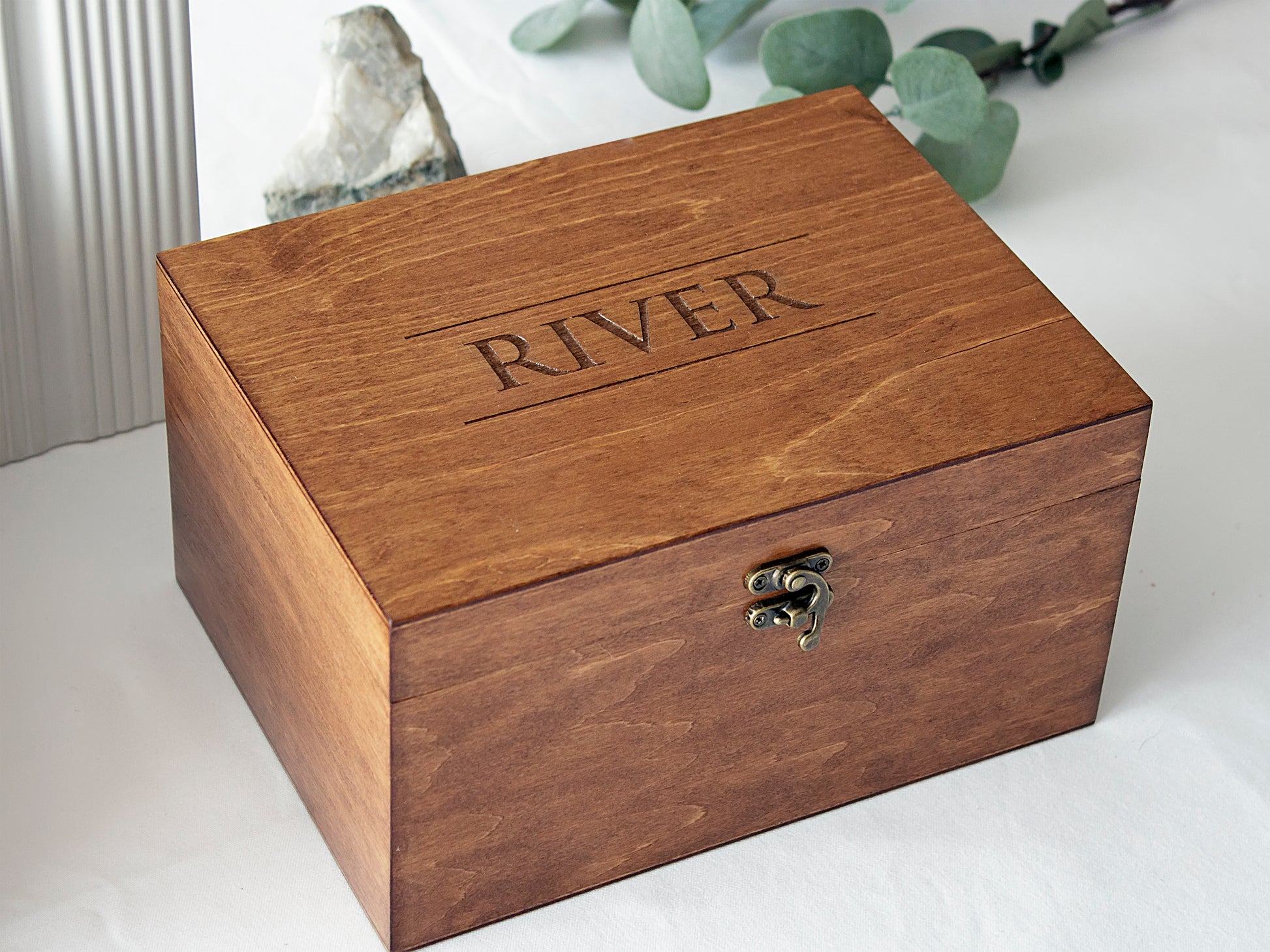 Personalized wooden memory box with the name 'RIVER' engraved on the lid, featuring a vintage bronze latch and walnut wood finish