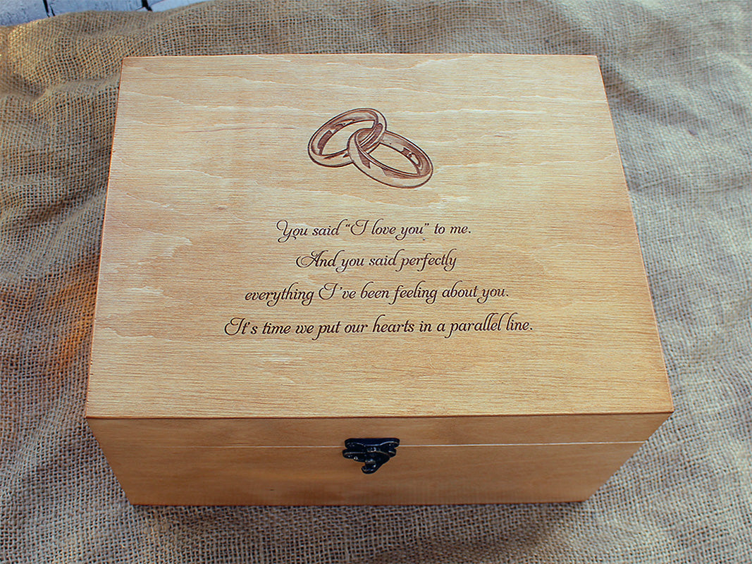 Custom engraved wooden wedding keepsake box with interlocking rings design and romantic love quote on a rustic burlap background