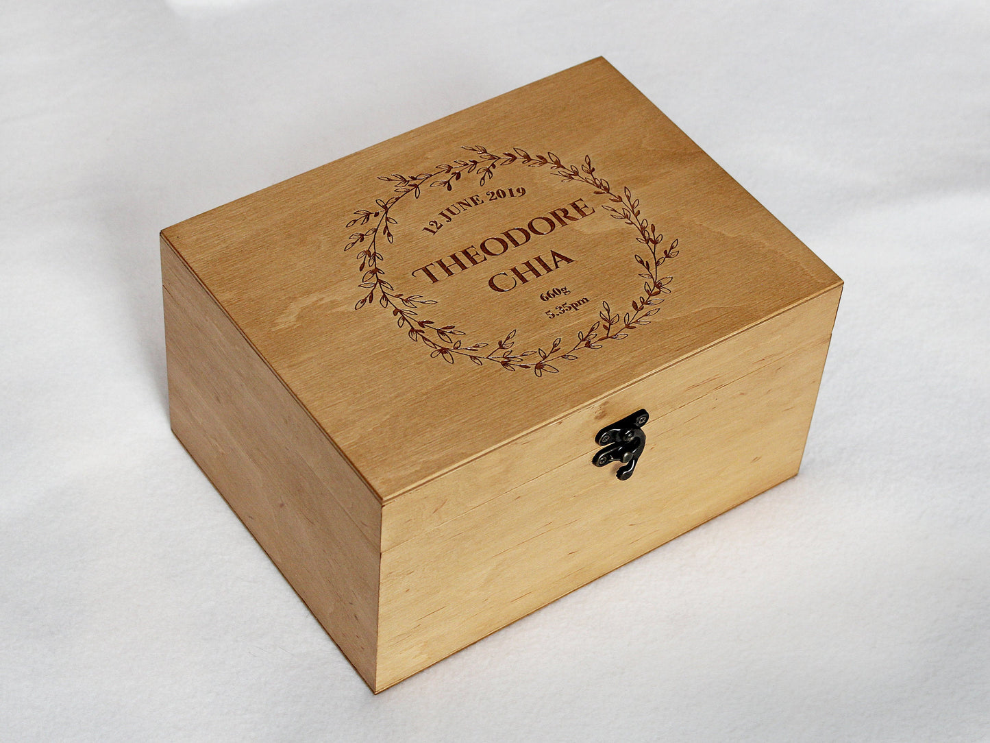 Baby memory box with personalized name engraved inside a floral wreath
