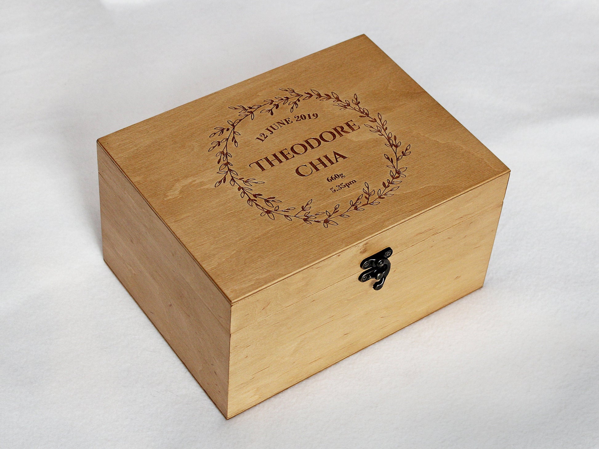 Baby memory box with personalized name engraved inside a floral wreath