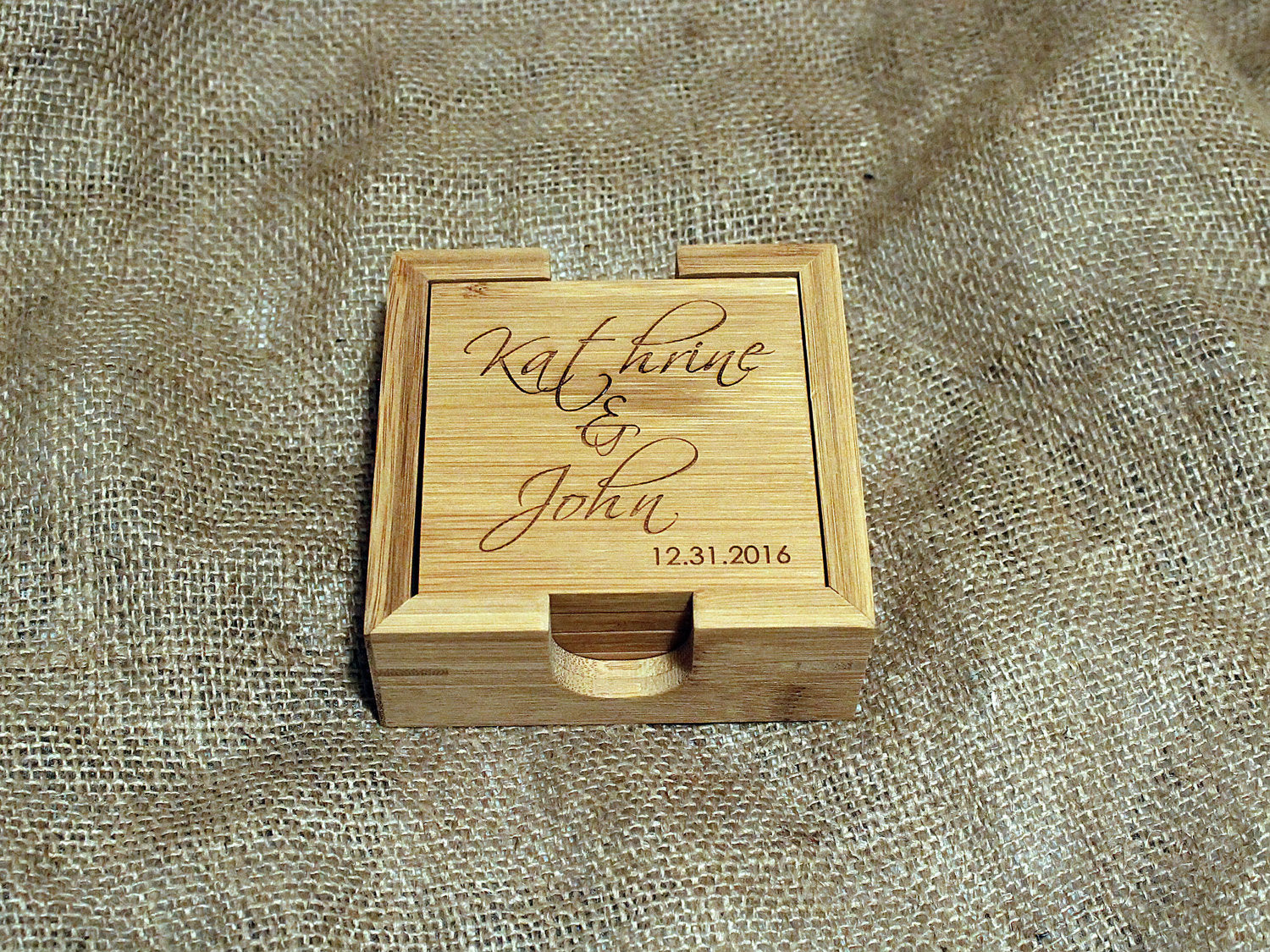 Set of custom bamboo coasters with different personalized engravings