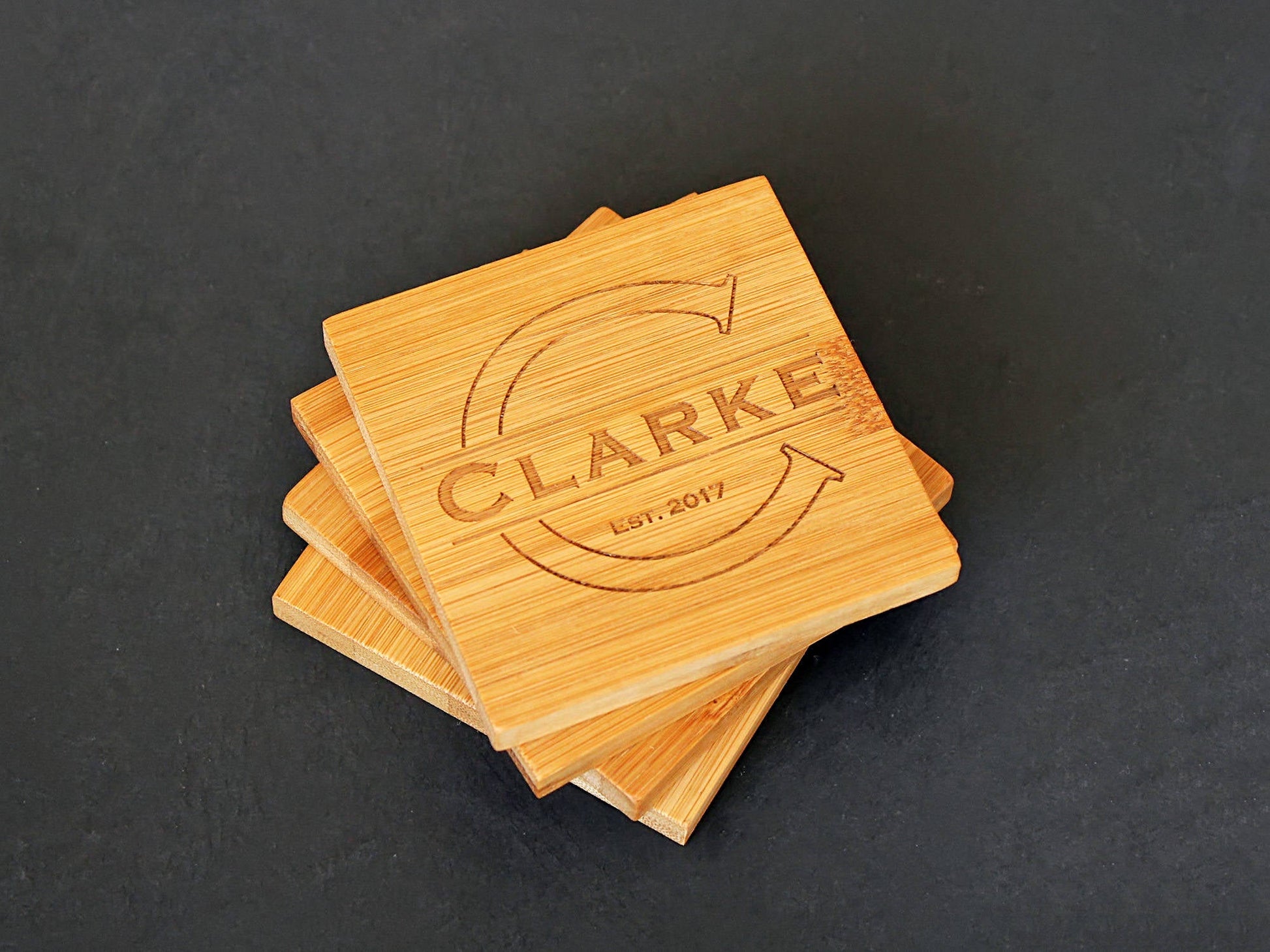 Custom initial engraving on a personalized bamboo coaster with monogram design