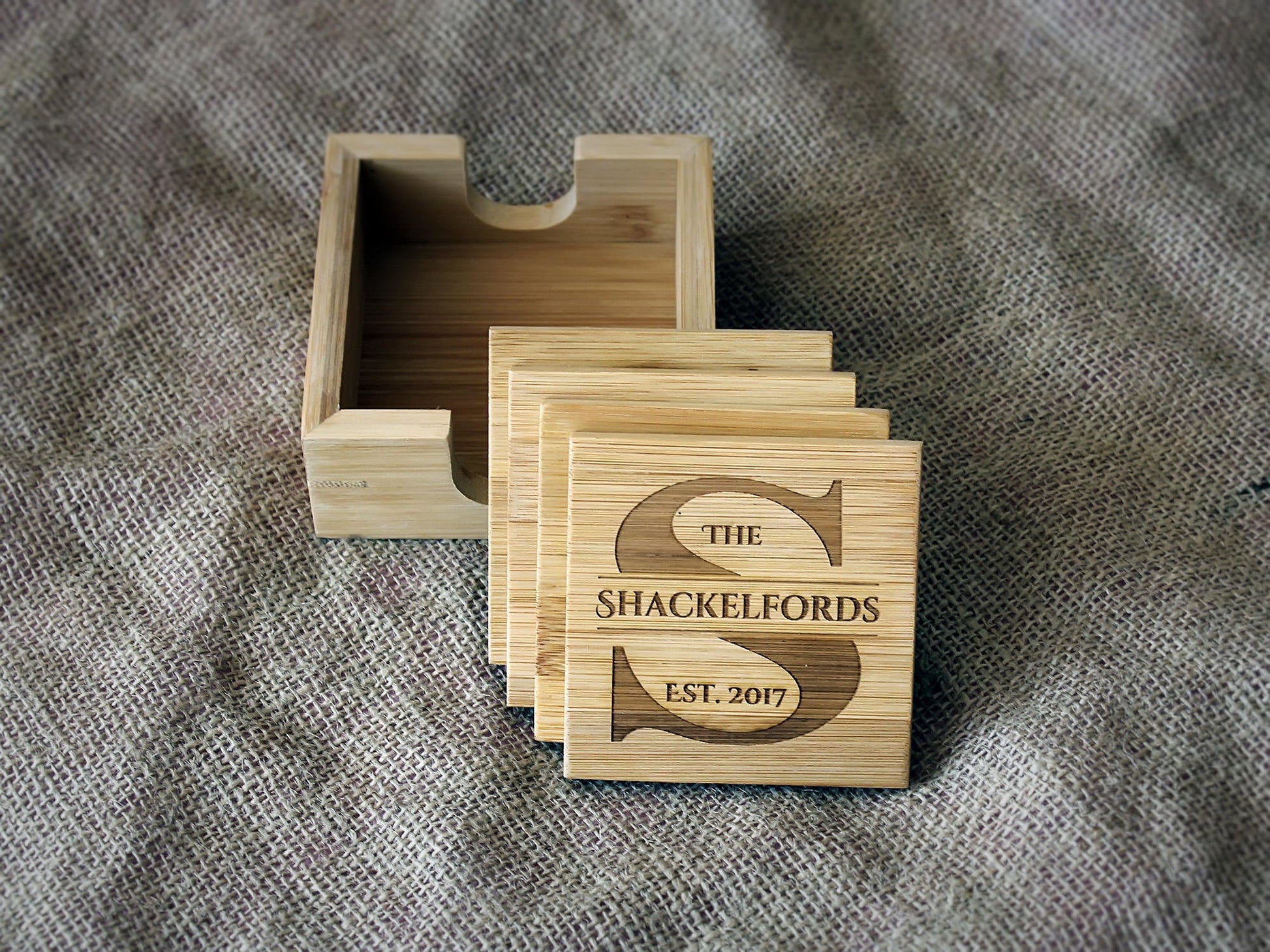 Close-up of a bamboo coaster with personalized monogram engraving
