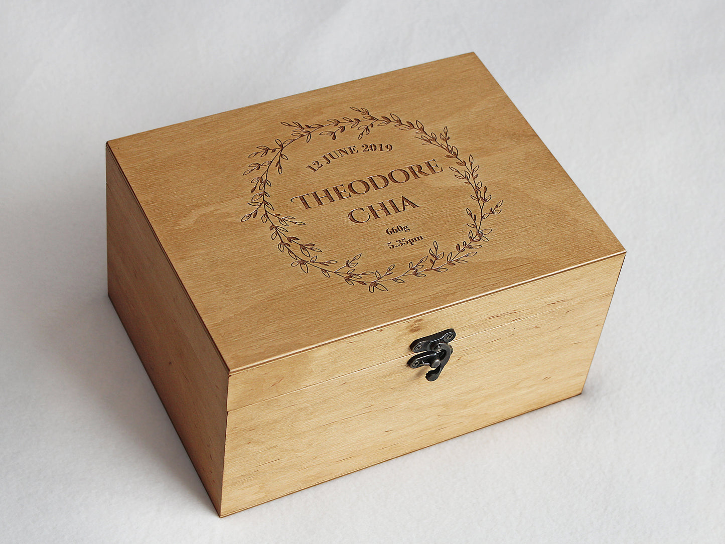 Personalized baby keepsake box with engraved floral wreath and custom details