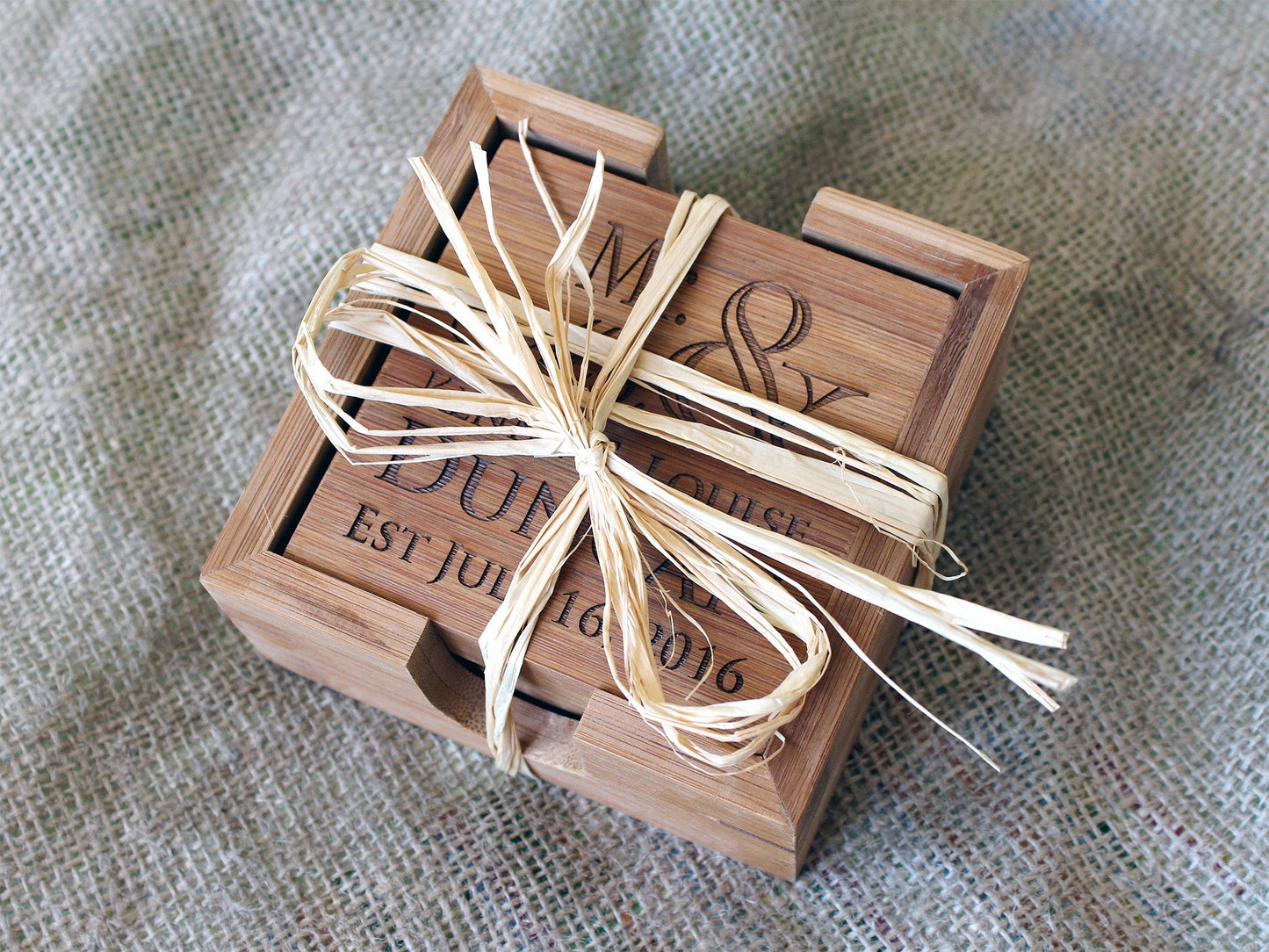 Close-up of a personalized bamboo coaster with custom engraved design