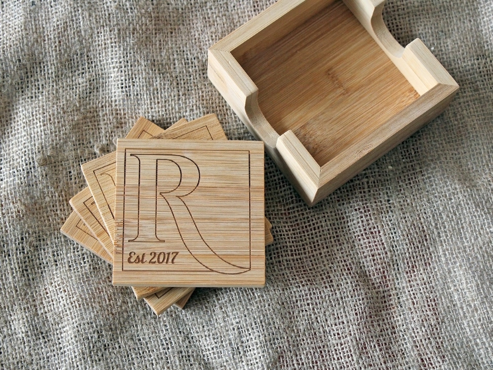 Custom bamboo coasters displayed on a home table