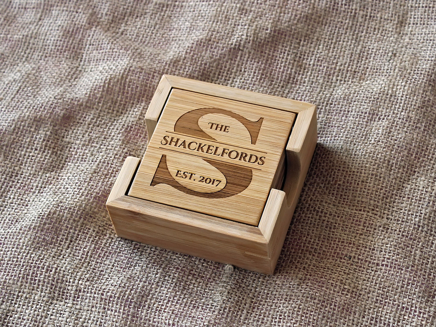 Personalized monogram bamboo coasters displayed as elegant home décor