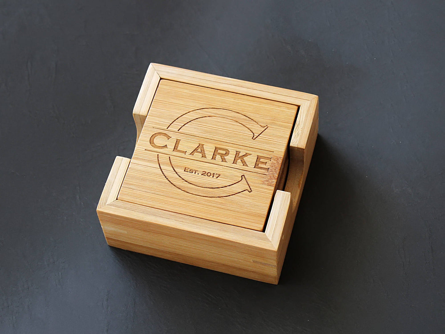 Close-up of a personalized bamboo coaster with custom monogram engraving