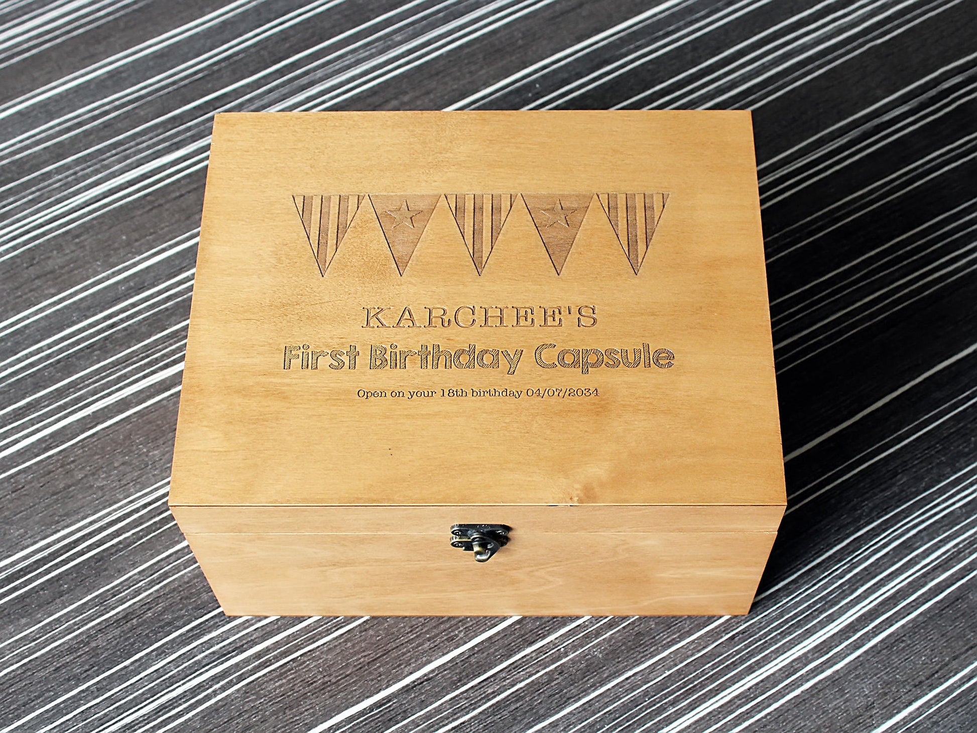 Custom engraved wooden memory box personalized with a unique design