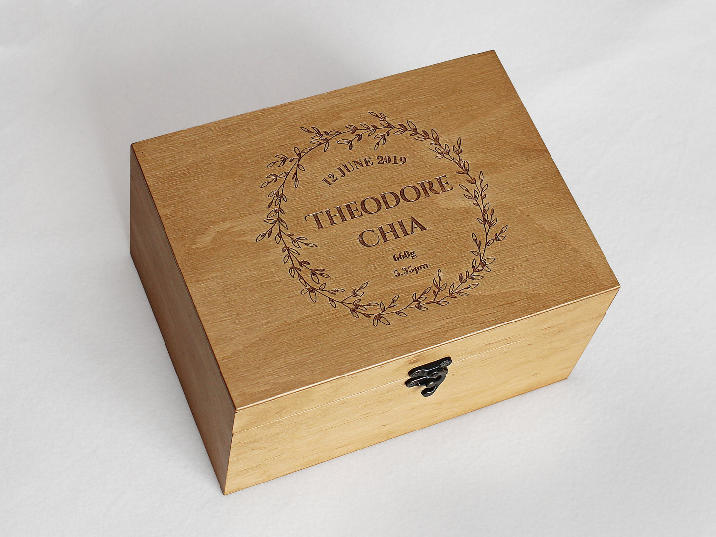 Personalized wooden memory box featuring a detailed floral wreath engraving